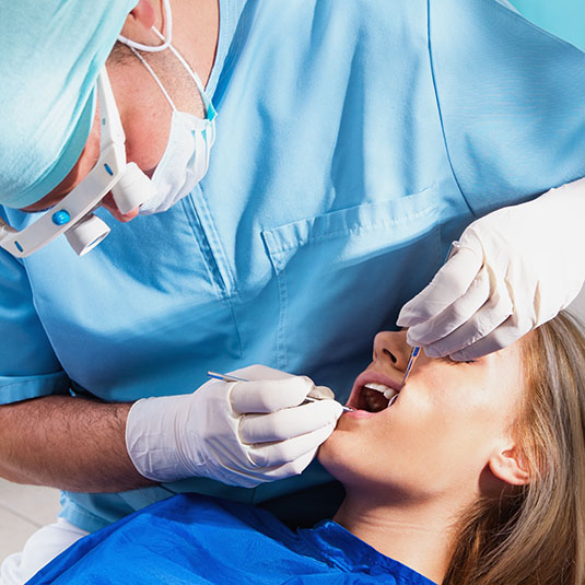 Photo of a dentist curing a girls teeth