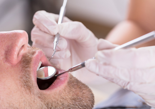 Male Patient Examined By Dentist